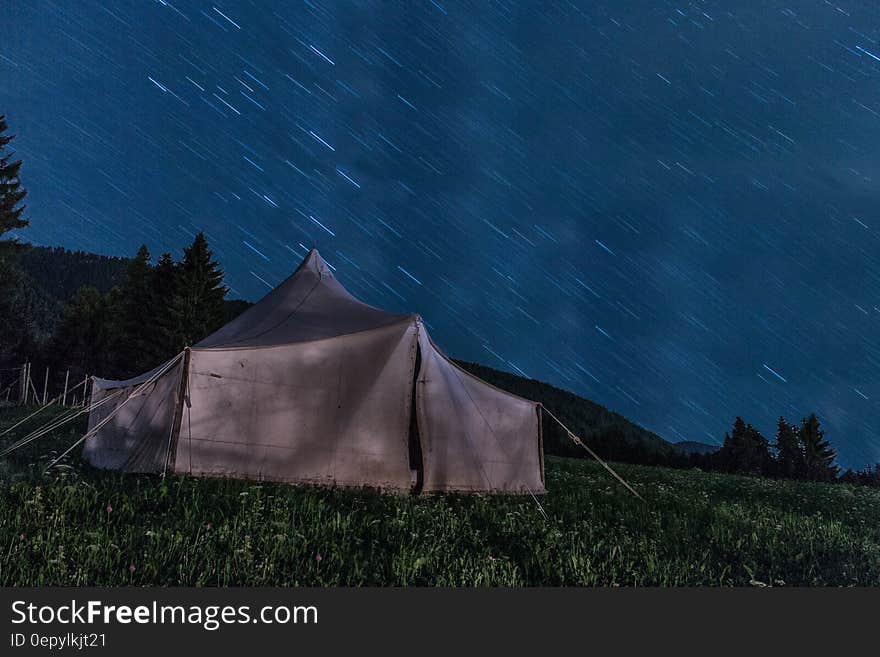 Brown Tent on Green Grass during Night Time