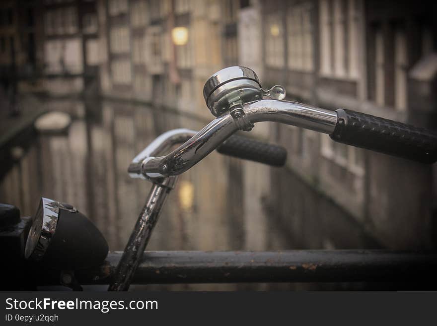 Black and Gray Bicycle Handle Bar With Bell Near Canal