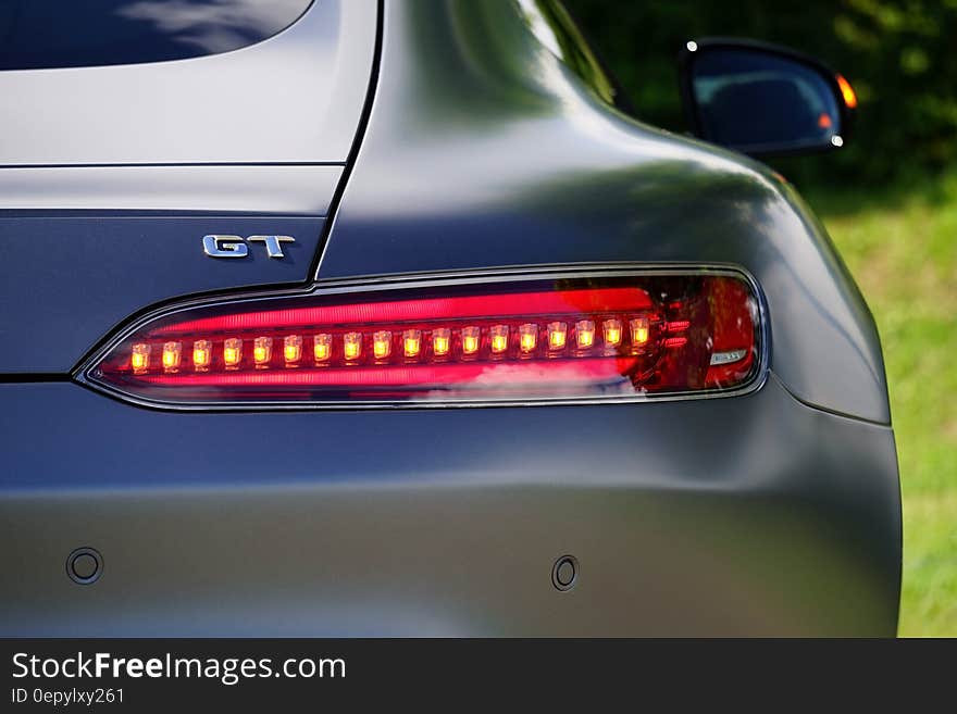 Close up on taillight and rear of blue sports car on sunny day. Close up on taillight and rear of blue sports car on sunny day.