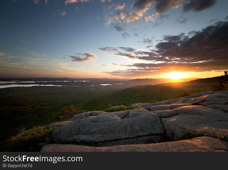 View of Green Grass Land and Sunset during Daytime