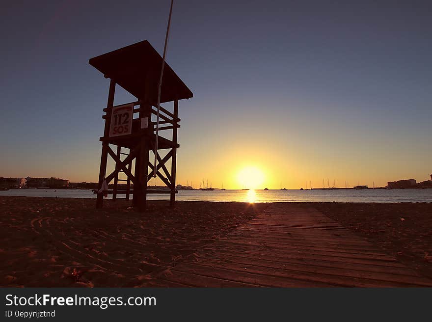 Wooden lifeguard chair on sandy beach at dawn. Wooden lifeguard chair on sandy beach at dawn.