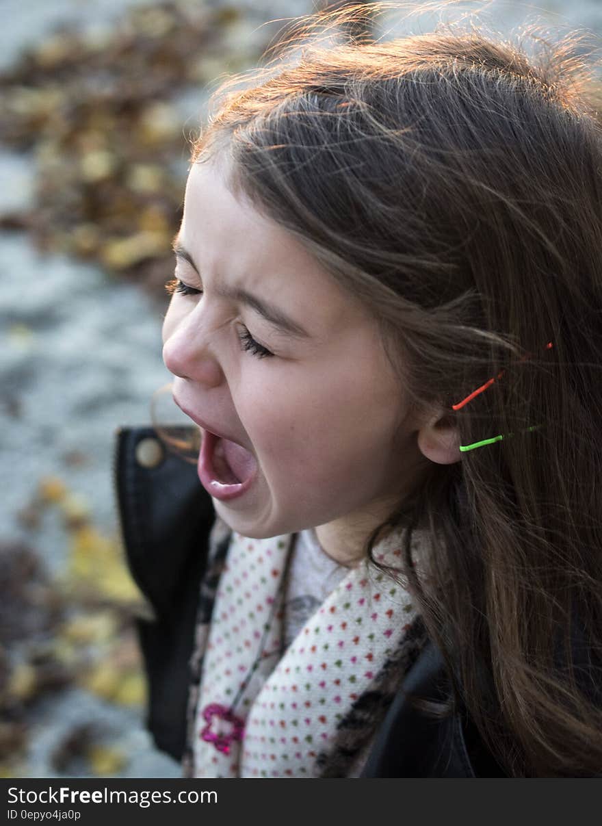 Girl Wearing Black Jacket and Gray Shirt With Open Mouth during Daytime