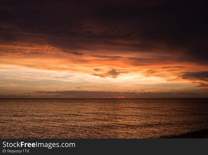 A sunset at sea with colorful skies.