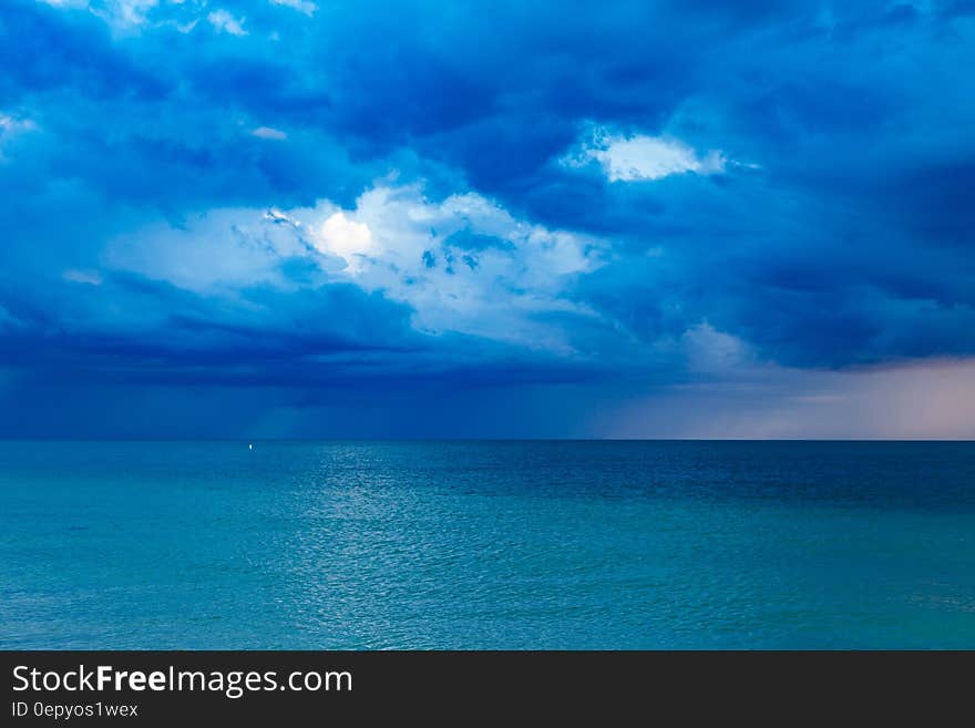 Blue Ocean With Cloudy Sky