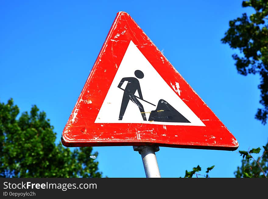 A traffic sign warning about road work.