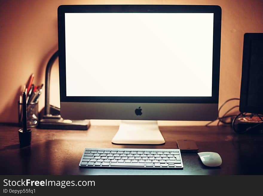 An Apple computer with an empty white monitor background. An Apple computer with an empty white monitor background.