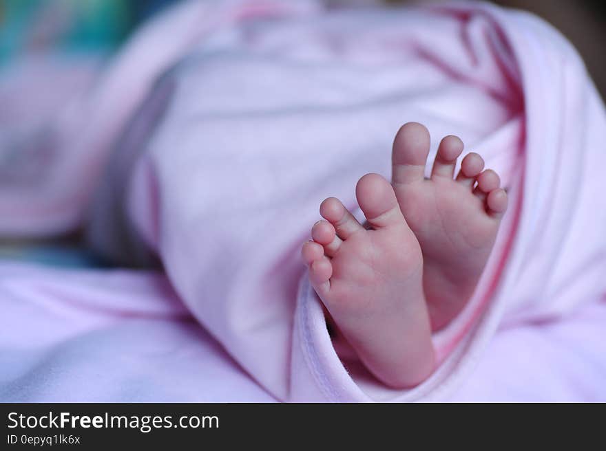 White Bed Spread Near a Human Foot during Night Time