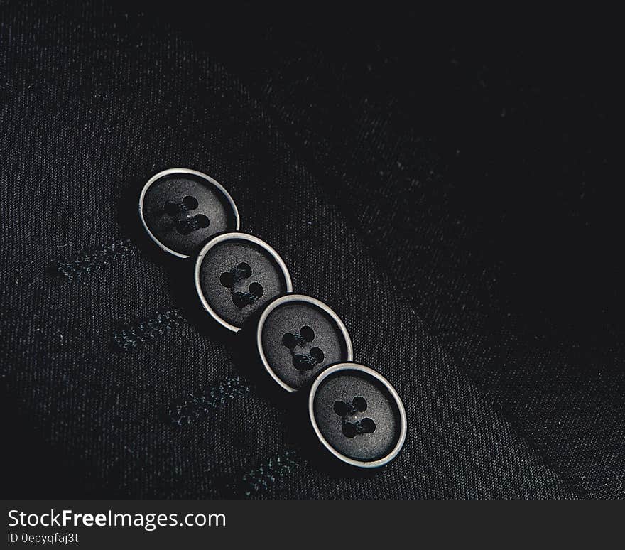 Close up of buttons on tailored sleeve in black and white. Close up of buttons on tailored sleeve in black and white.