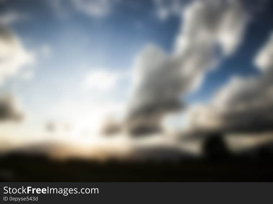 Abstract blurry background with white clouds in blue sky. Abstract blurry background with white clouds in blue sky.