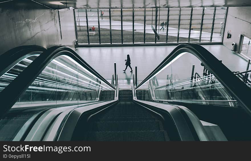 Escalator in sunny atrium in modern building. Escalator in sunny atrium in modern building.