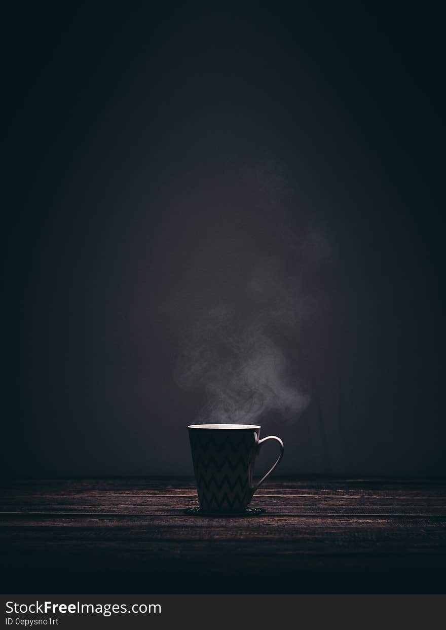 Coffee cup with steam on wooden tabletop with copy space. Coffee cup with steam on wooden tabletop with copy space.