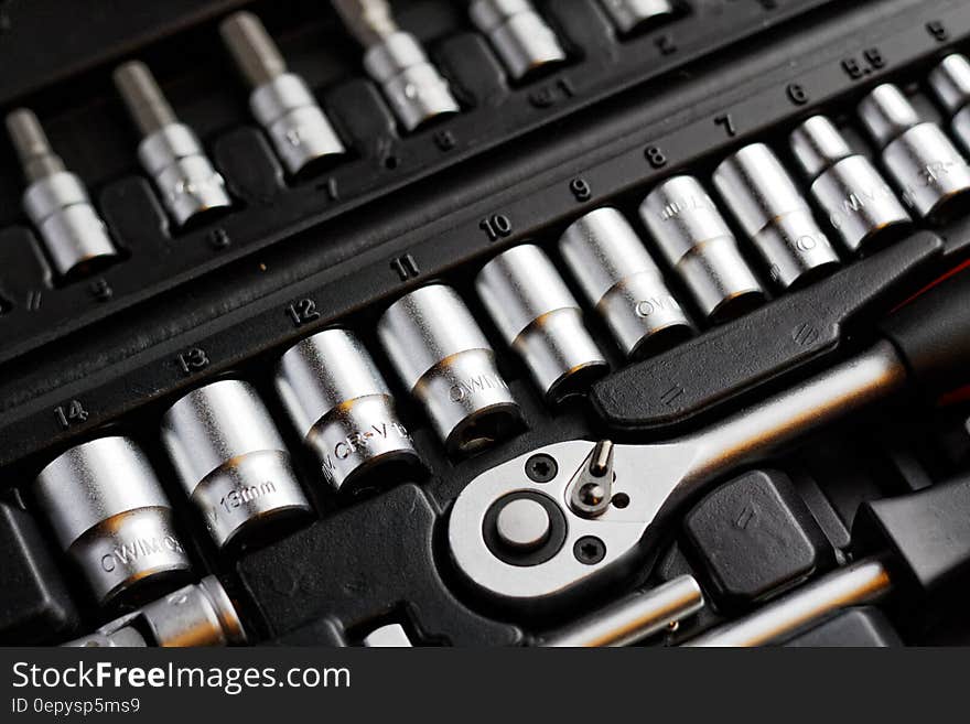 Close up of wrench handle with interchangeable heads in plastic toolbox. Close up of wrench handle with interchangeable heads in plastic toolbox.