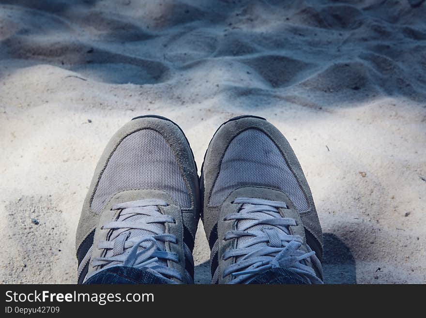 Grey Shoes on Top of Grey Sand