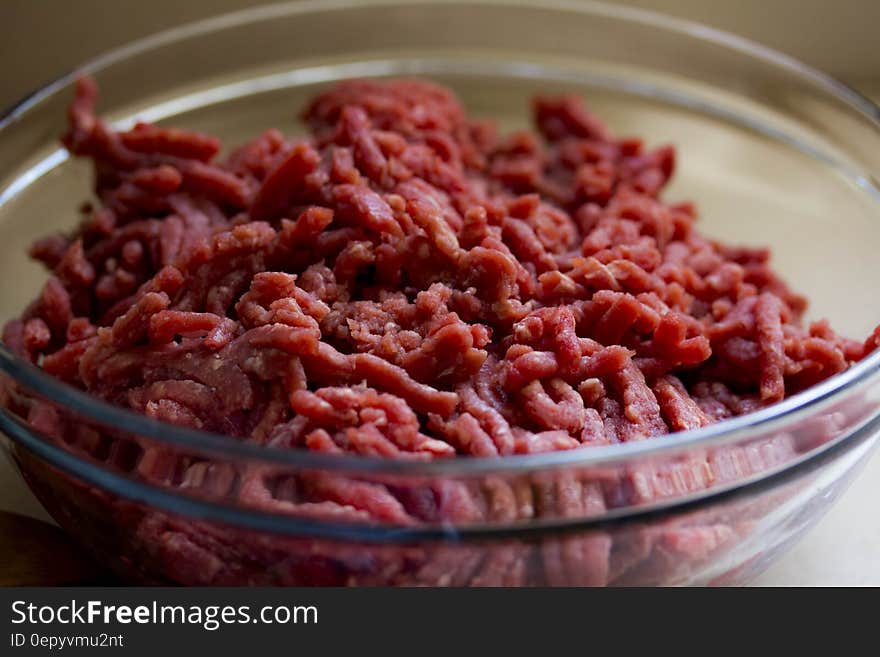 Close up of ground beef in glass bowl. Close up of ground beef in glass bowl.