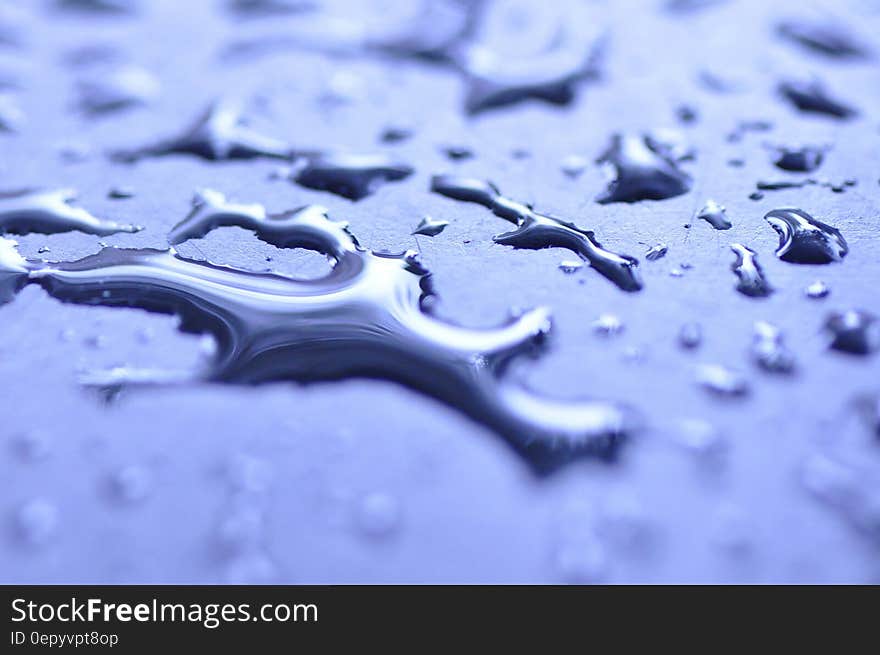 Dew Drops of Water on Blue Surface