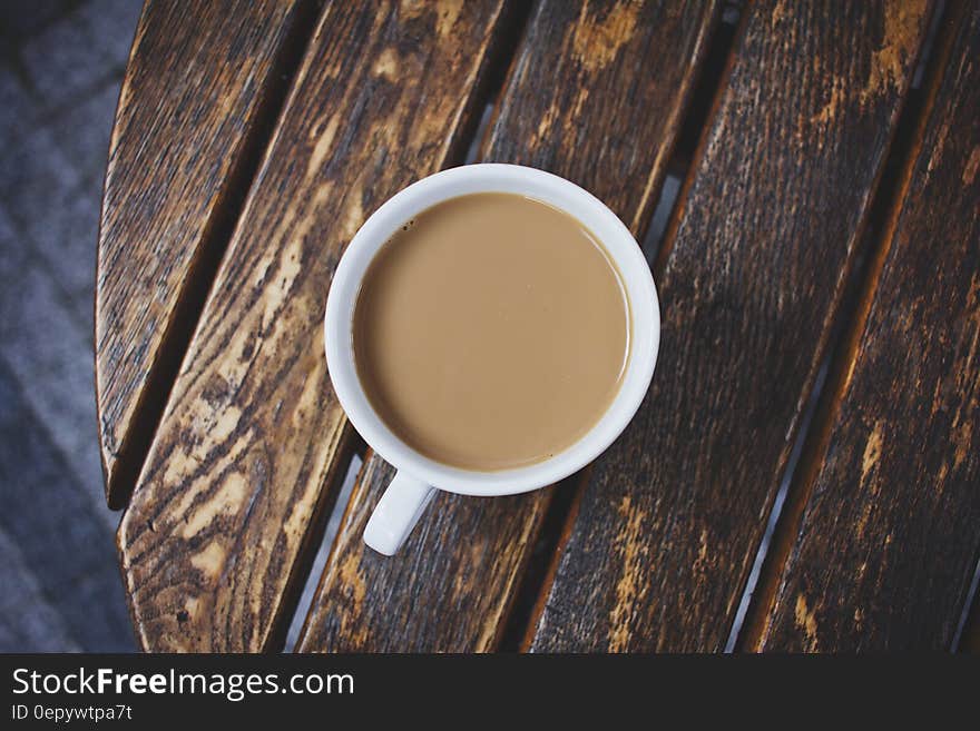 White Ceramic Teacup on Brown Wooden Table