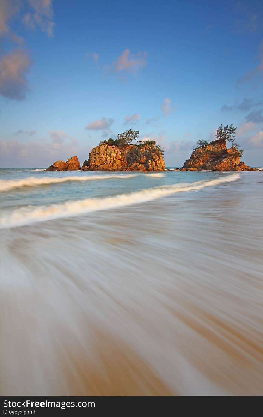 Brown Rock Formation Along the Sea during Daytime