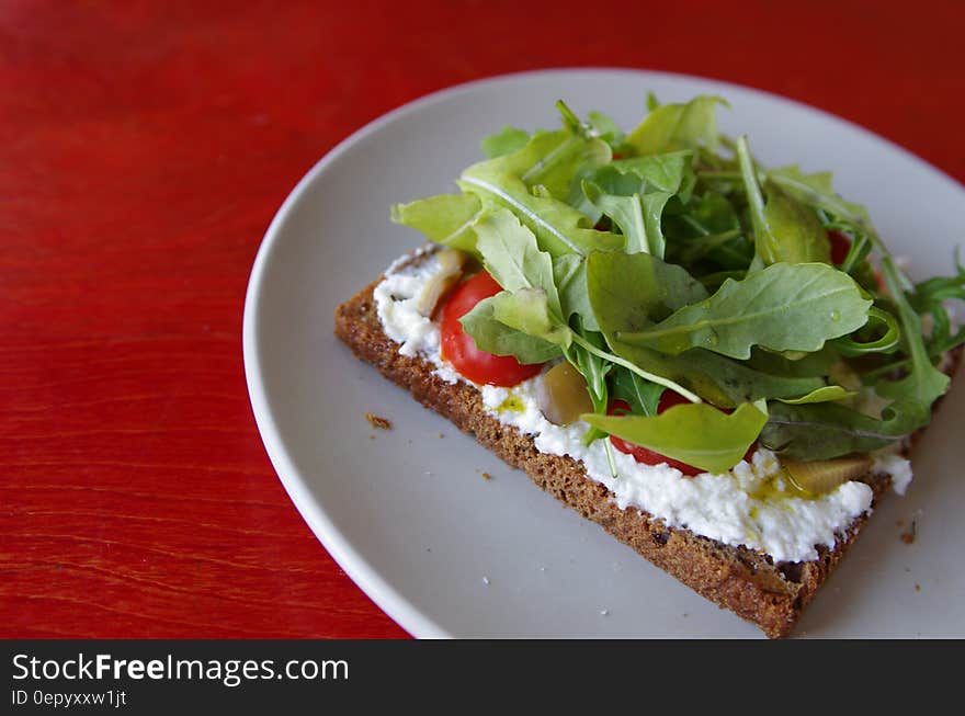 Baked Pastry With Cream and Salad on Top