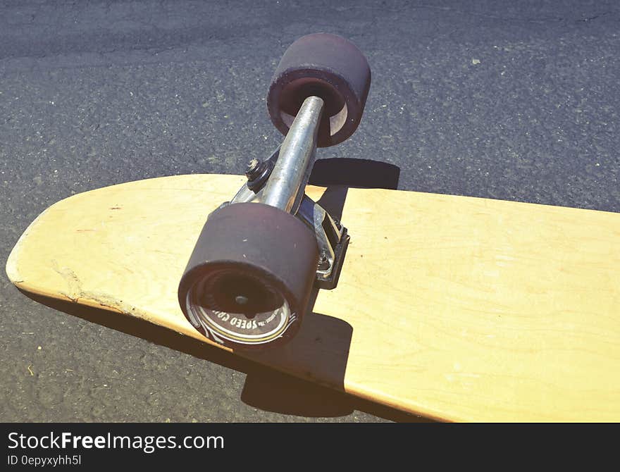 Brown Skateboard on Concrete Road