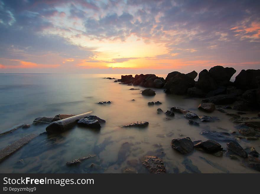 Black Rock Formation on the Sea during Sunset