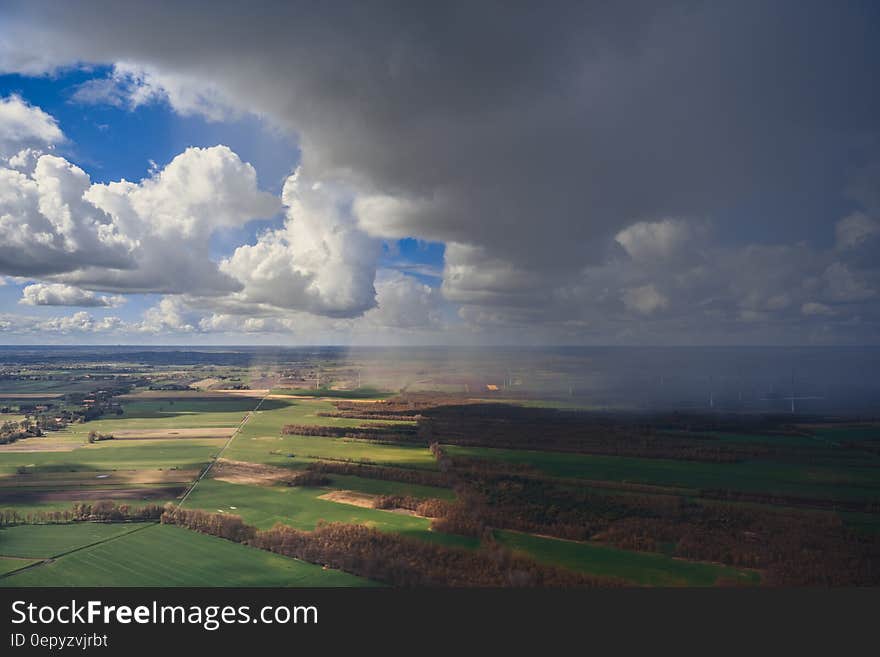 White clouds in blue skies over rural agricultural fields on sunny day. White clouds in blue skies over rural agricultural fields on sunny day.