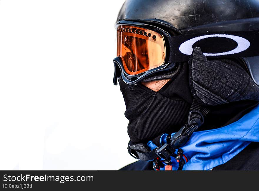 Macro Photo of Person in Black Goggles and Black Face Mask