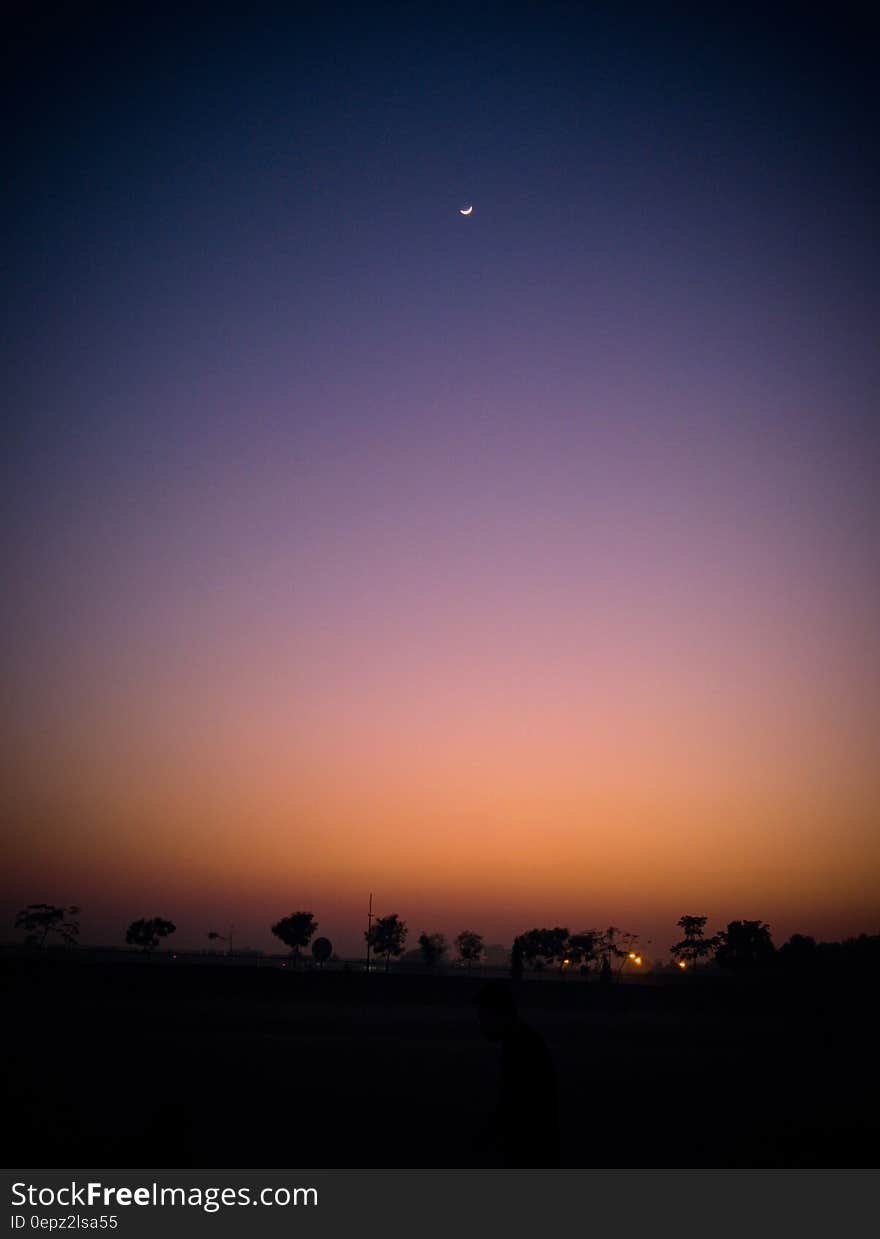 Colored clear sky at dusk and sickle moon high up. Colored clear sky at dusk and sickle moon high up.