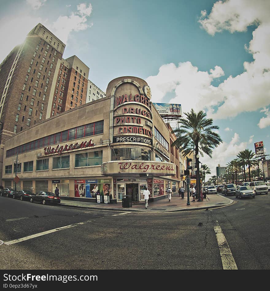 A shopping mall in an urban city quarter and a palm tree next to it. A shopping mall in an urban city quarter and a palm tree next to it.