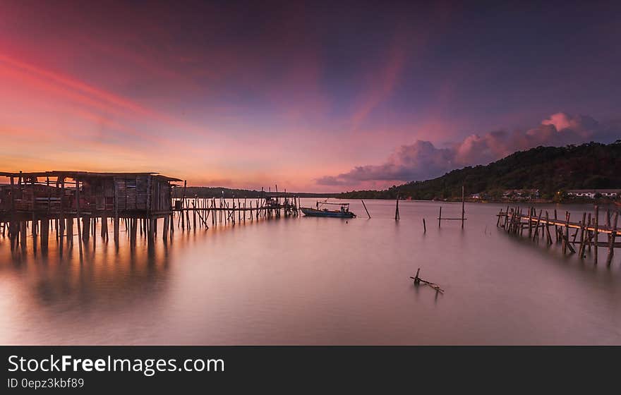 A beach with wooden pier at sunset. A beach with wooden pier at sunset.