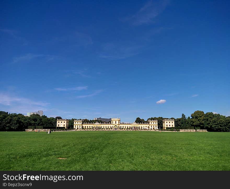 Mansion on green lawn at Karlsaue Park in Kassel, Germany with blue skies on sunny day. Mansion on green lawn at Karlsaue Park in Kassel, Germany with blue skies on sunny day