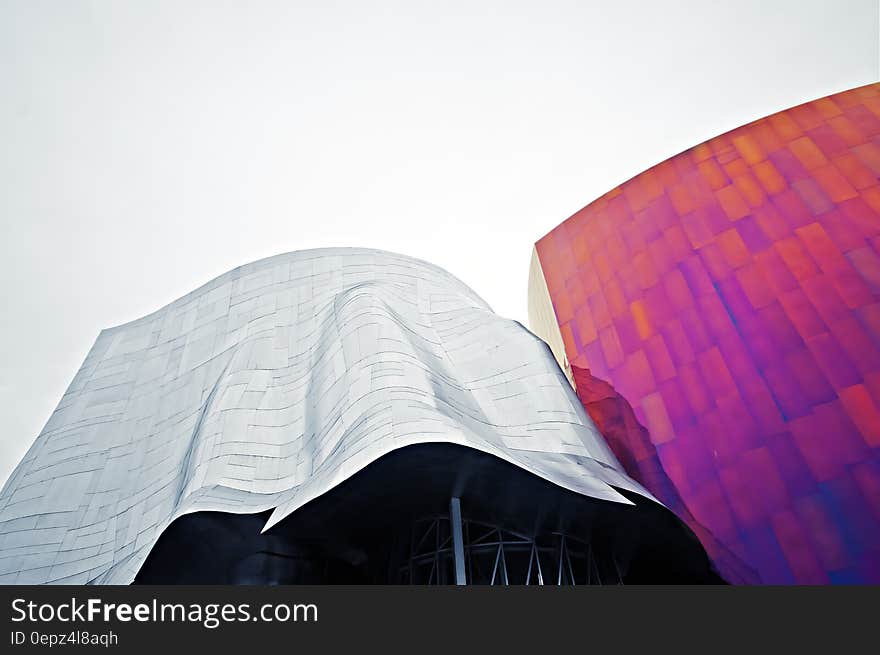 Exterior of modern architecture with red and silver panels on sunny day. Exterior of modern architecture with red and silver panels on sunny day.