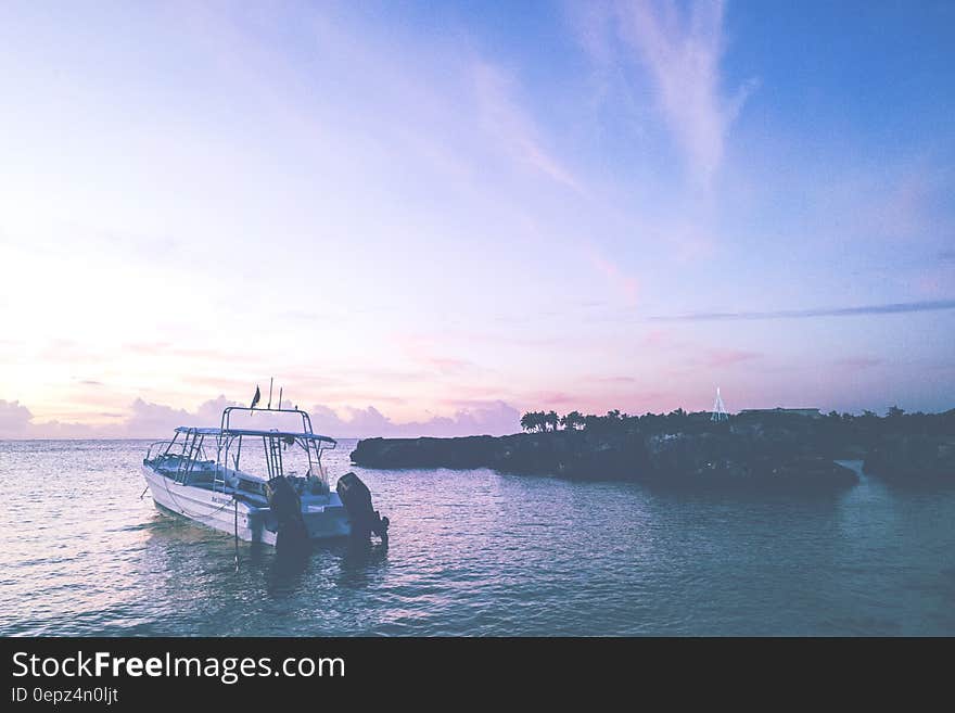 Boat moored off coastline a sunset. Boat moored off coastline a sunset.