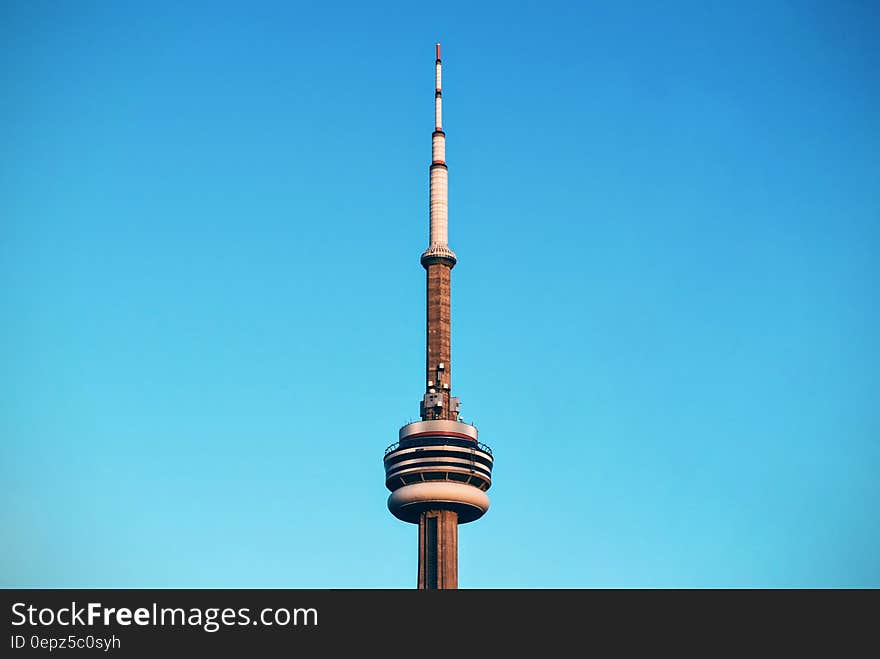 Top of CNN Tower in Toronto, Canada against blue skies on sunny day. Top of CNN Tower in Toronto, Canada against blue skies on sunny day.