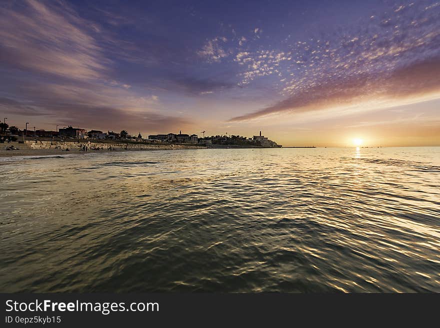 An evening at the sea with the sun setting behind the horizon. An evening at the sea with the sun setting behind the horizon.