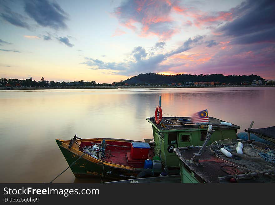 A boat on a river at sunset. A boat on a river at sunset.