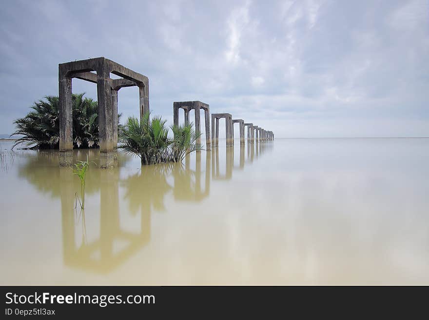 A flooded landscape with concrete structures rising from the water.