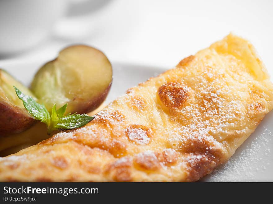 A fried bread with fruits on plate.