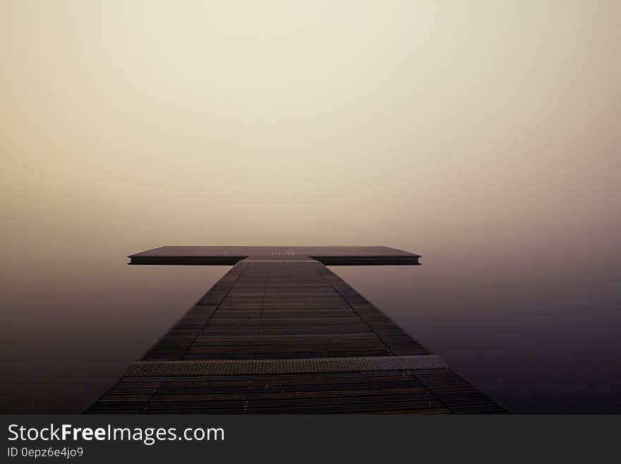 T shaped wooden jetty sticking out over a lake on a very foggy day. T shaped wooden jetty sticking out over a lake on a very foggy day.