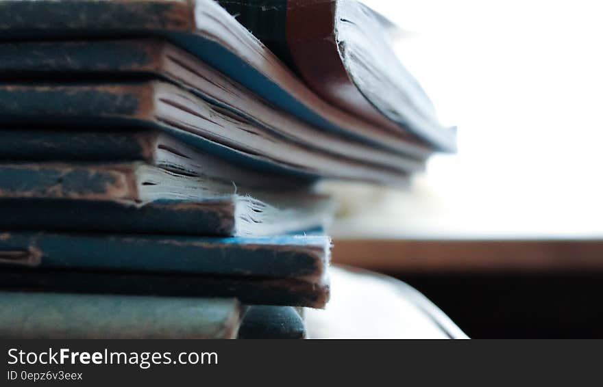 A stack of old worn down notebooks. A stack of old worn down notebooks.