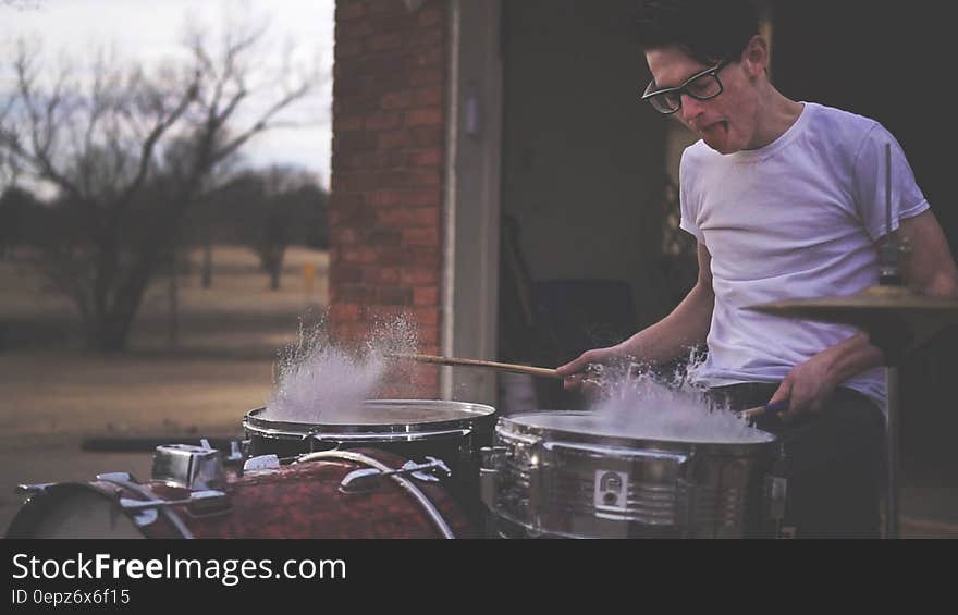 Person Playing on Drums during Daytime