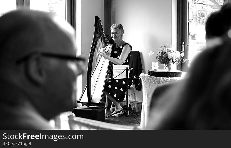 Woman Playing Harp on Stage Grayscale