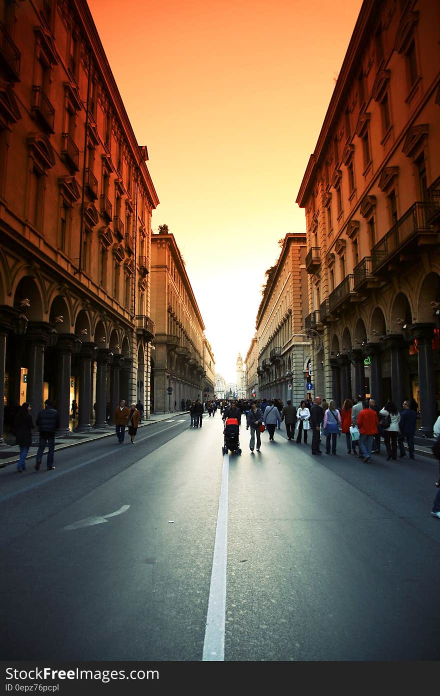 A view of a city street with pedestrians walking. A view of a city street with pedestrians walking.