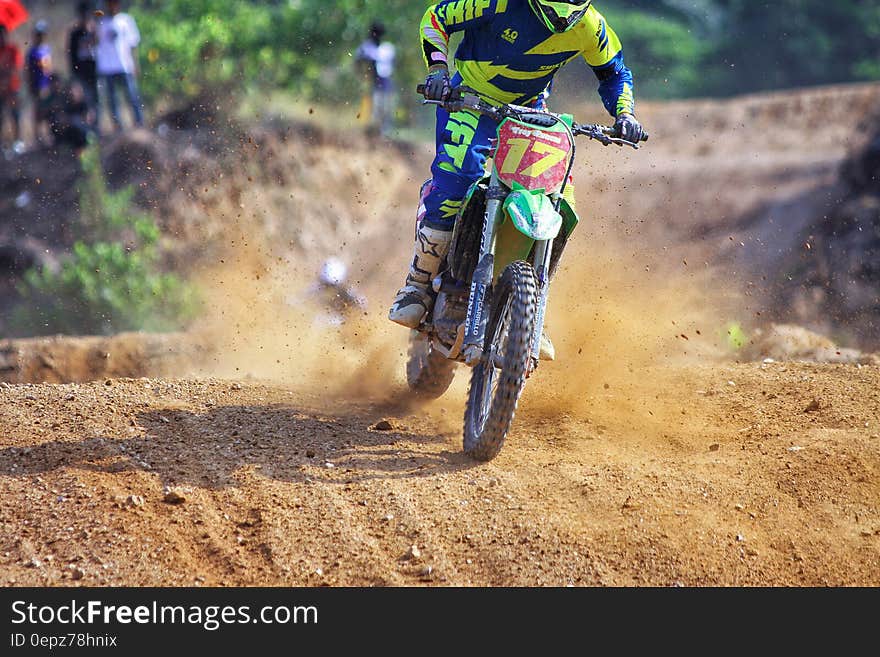 Man Riding Green Dirt Motorcycle during Daytime