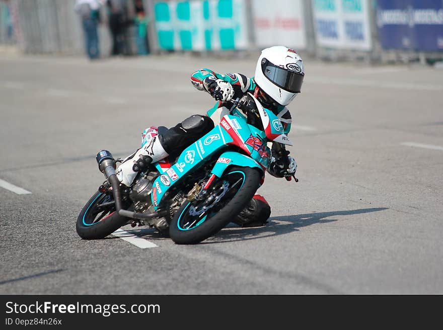 Biker Riding a Teal Sport Bike