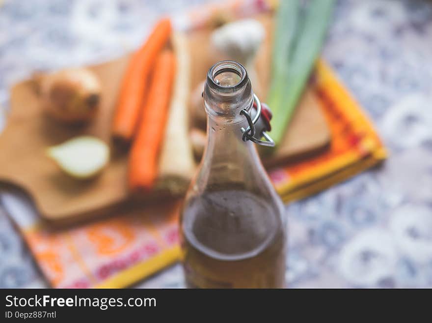 Clear Glass Bottle With Brown Liquid in Selective Focus Photography