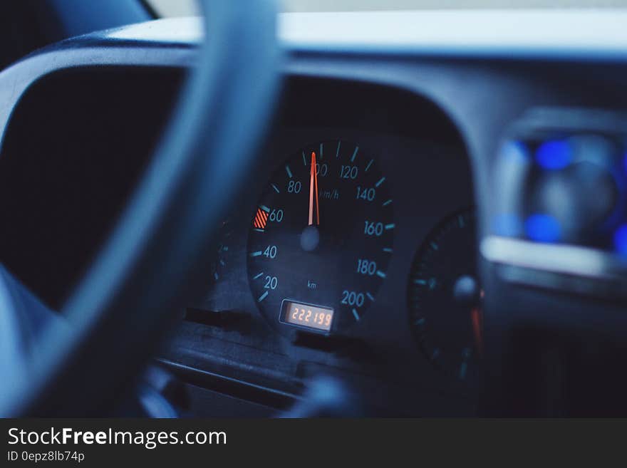 Close up of speedometer and steering wheel inside car. Close up of speedometer and steering wheel inside car.