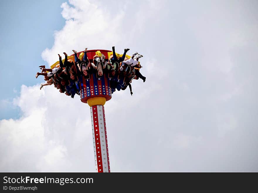 People Riding on White and Red Carnival Rides