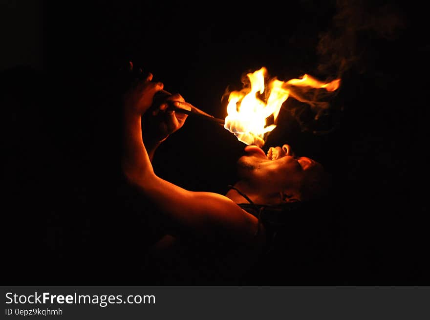 Portrait of male fire eater performer at night. Portrait of male fire eater performer at night.