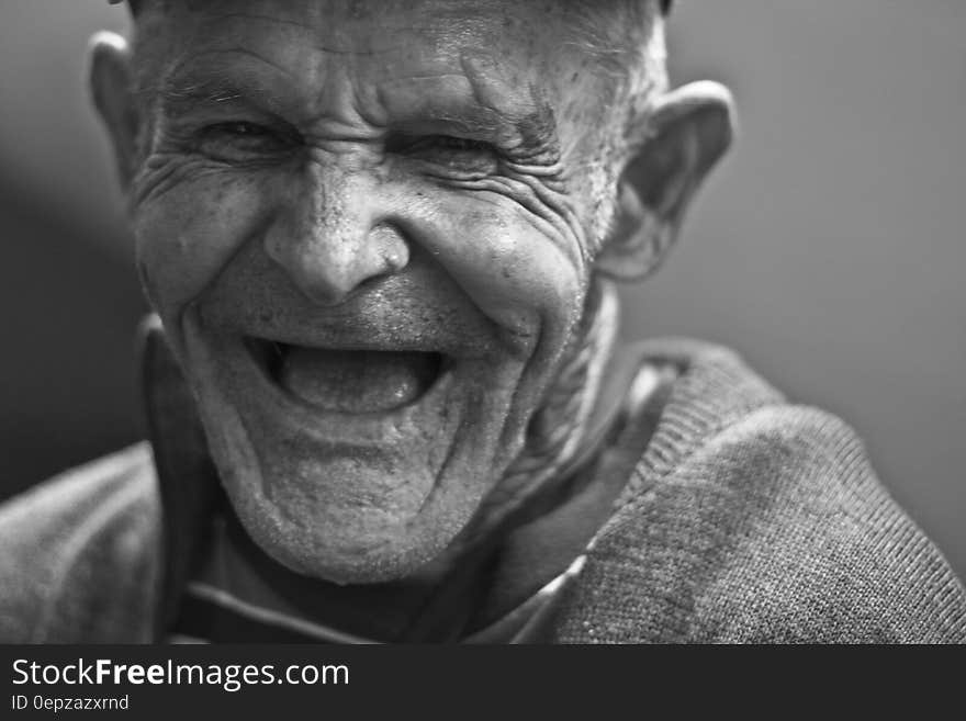 Grayscale Photo of Laughing Old Man