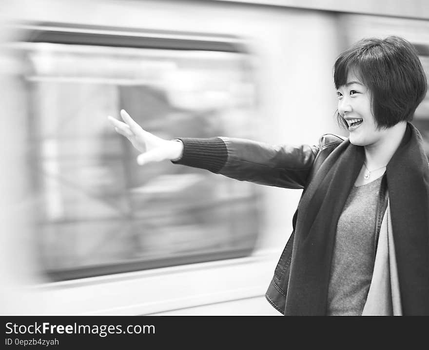 Grayscale Photography of Woman Raising Right Arm